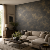 Living room with a dark accent wall finished in Moonlight decorative paint in charcoal with irregular golden metallic highlights creating an aged patina effect.