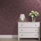 Silver Sand decorative paint in Claret 40 shade with a wind-blown sand textured pearlescent finish on a wall